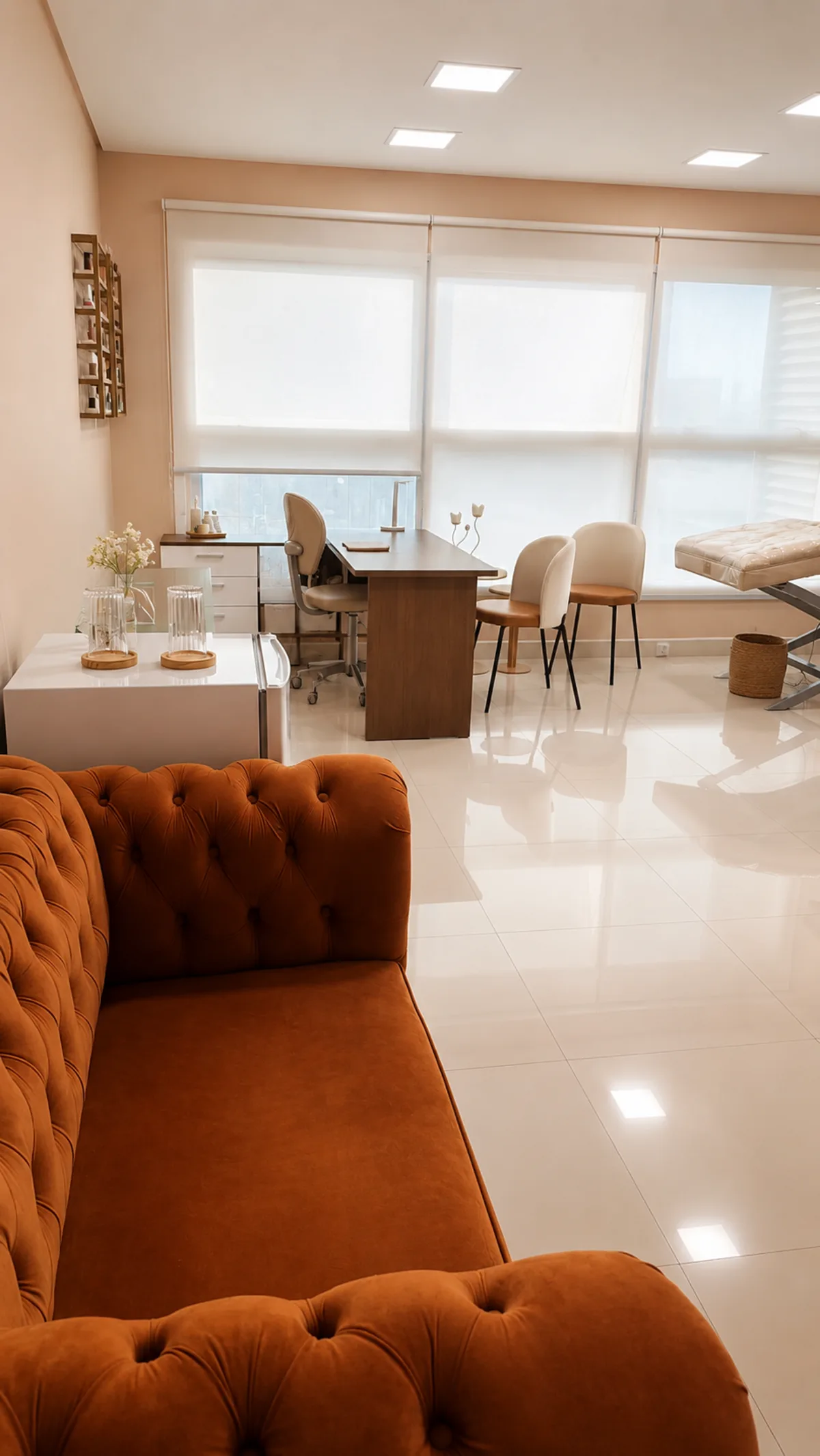 Recepção com sofá veludo e área de espera iluminada
